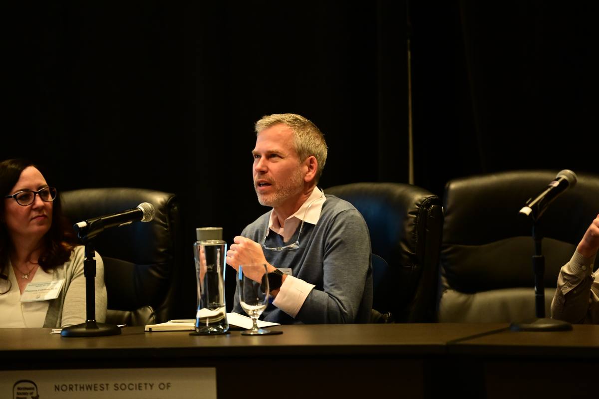 A panellist makes a point while colleagues on the panel listen
