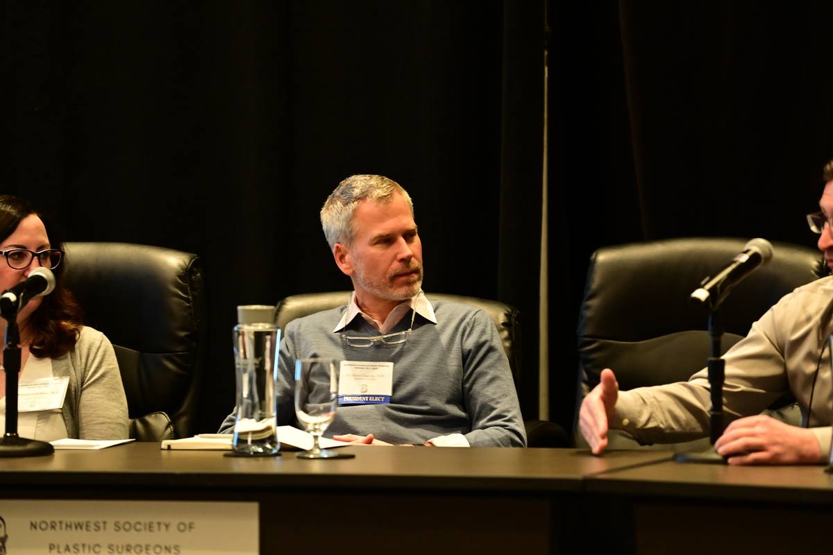 Panellists seated at a long table with microphones during a session